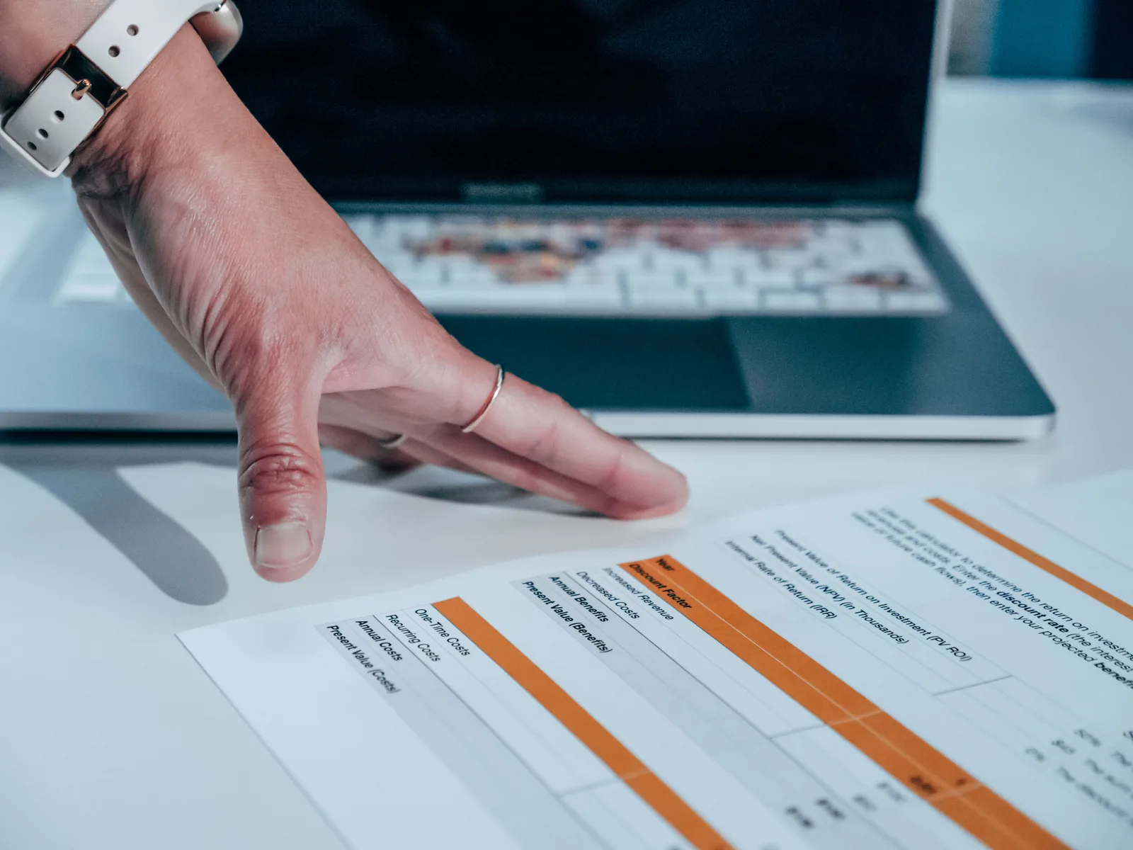 Close-up of a hand reviewing a financial report on a laptop, indicating focus on business analysis. Why do certain membership community KPIs actually predict churn?